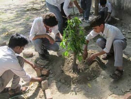 Students plant trees during Gaga Action Parivar's Mother Earth Day Celebrations